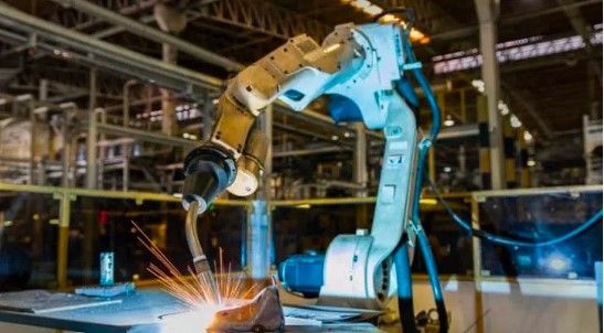 An image of an industrial robotic arm doing a welding task.