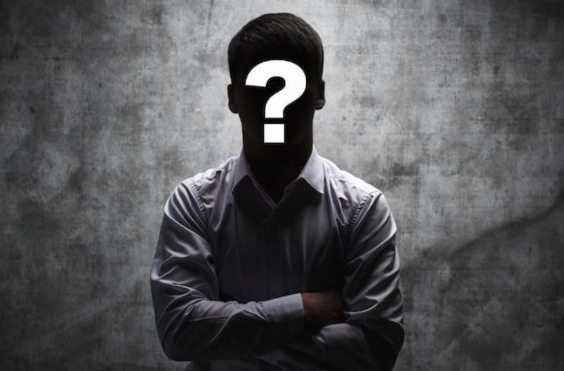 Figure 4 – Unknown man to be identified (Premium Photo | Anonymous man in a business shirt with a question mark on his face on a dark background)