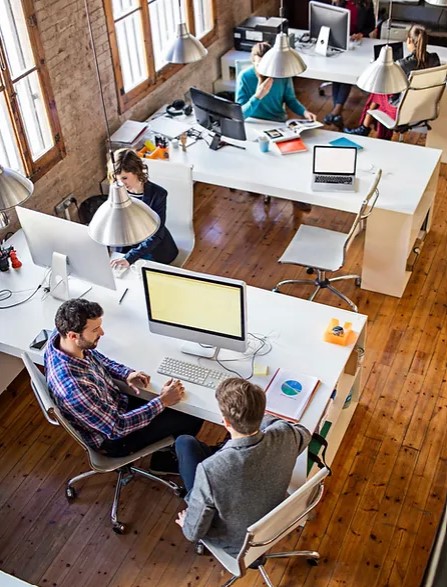 A team of five people working in a modern office
